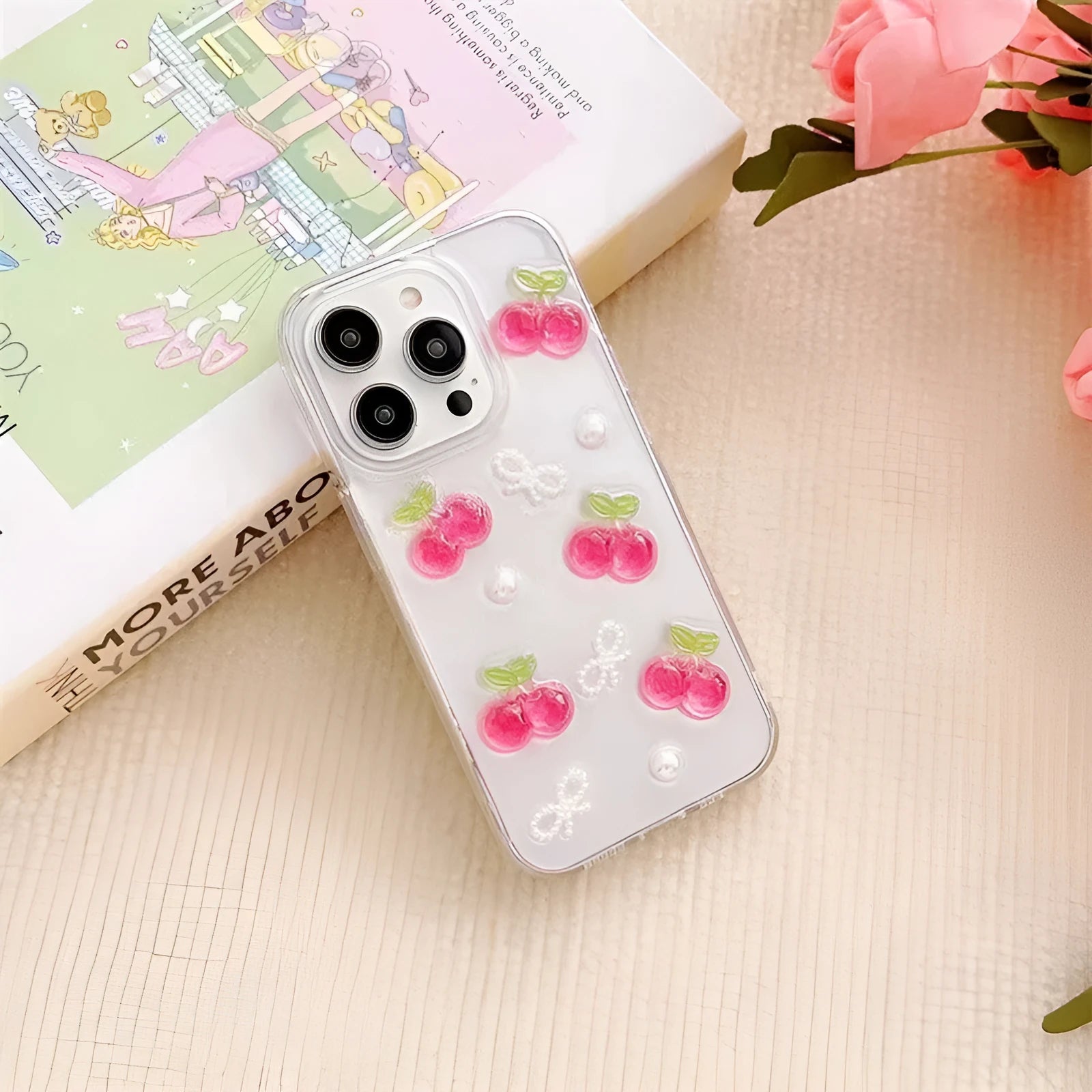 Epoxy three-dimensional cherry bow phone case in transparent finish showing decorative cherry and bow design on front