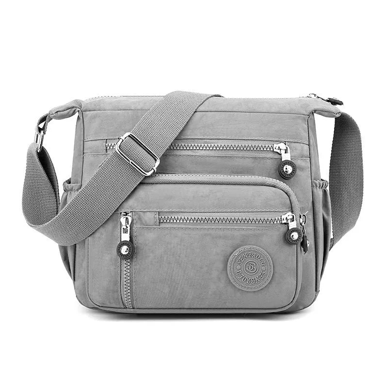 Nylon messenger bag in grey colour with single shoulder strap and square vertical design