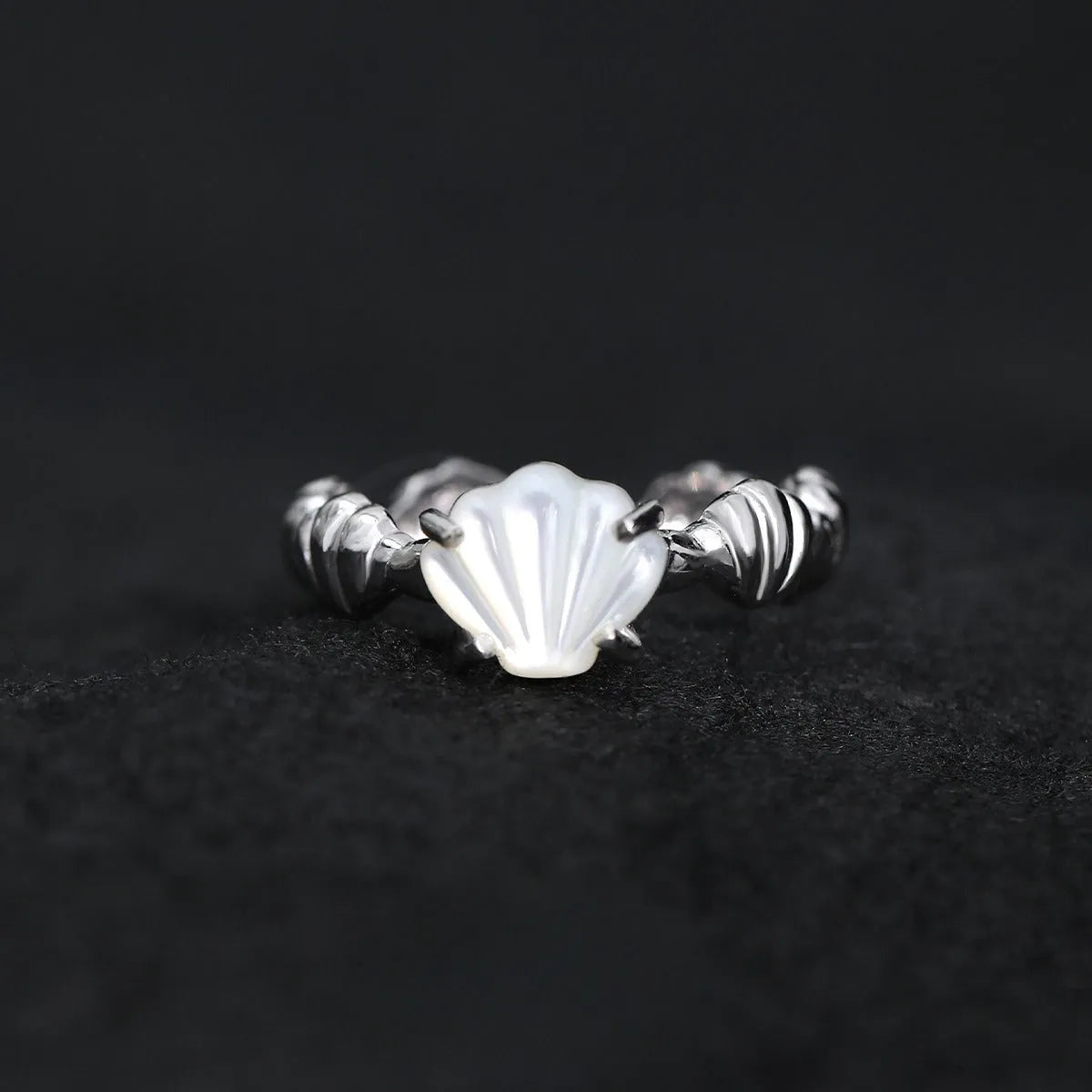 Women's adjustable sterling silver ring with shell decoration and tiger eye stone in original cold-style design