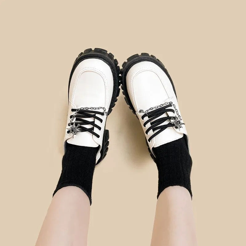 Women's Duke Asterism loafers with preppy style, round toe, and cross strap with metal detail.