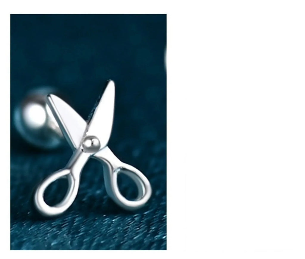 A pair of pure silver screw-style earrings for cartilage piercings with mini scissors screw details.