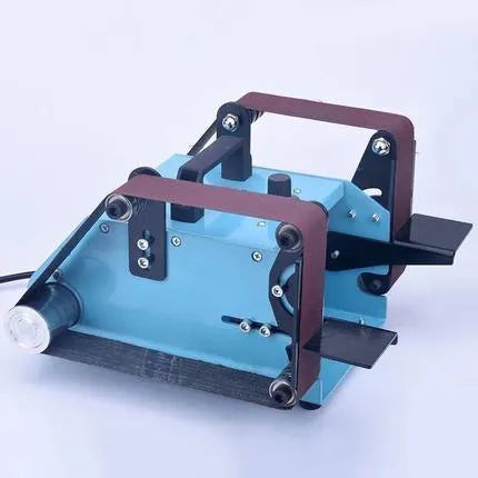 Blue desktop dual-axis belt sander for polishing and knife sharpening on a workbench.