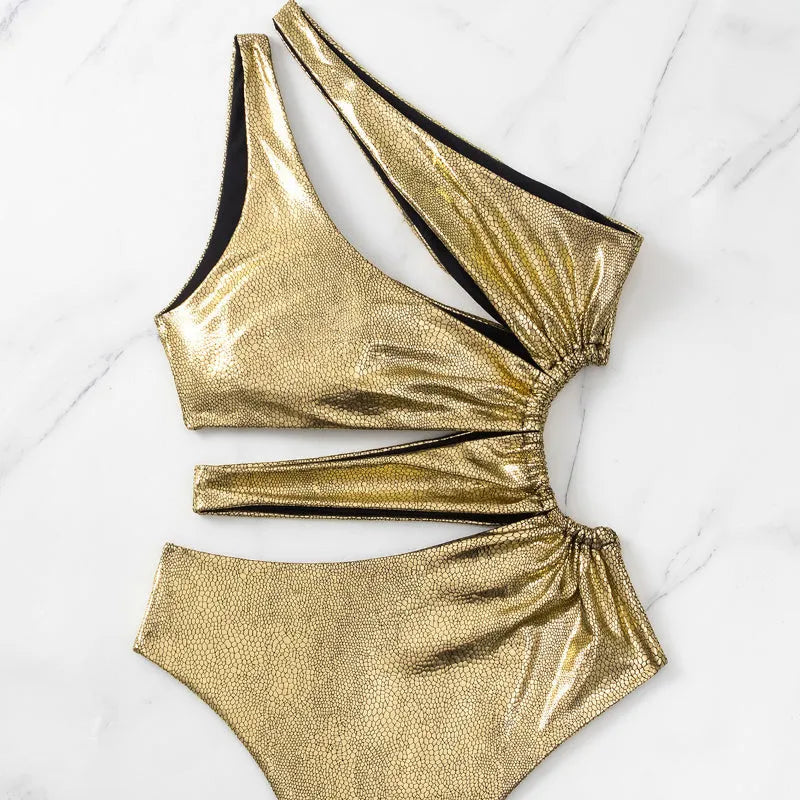 Women's gold backless one-piece swimsuit on hanger showing sleeveless design