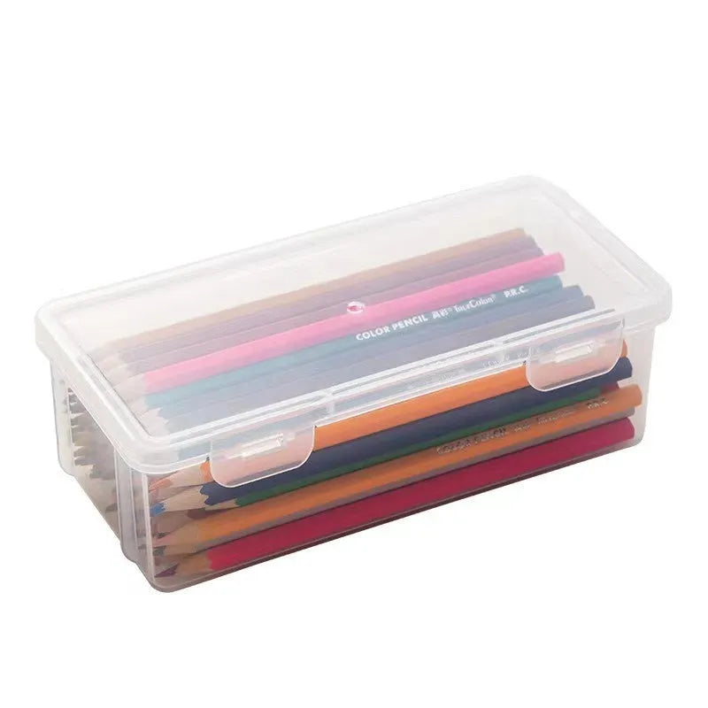 Large clear plastic stationery storage box filled with coloured pencils and wax crayons