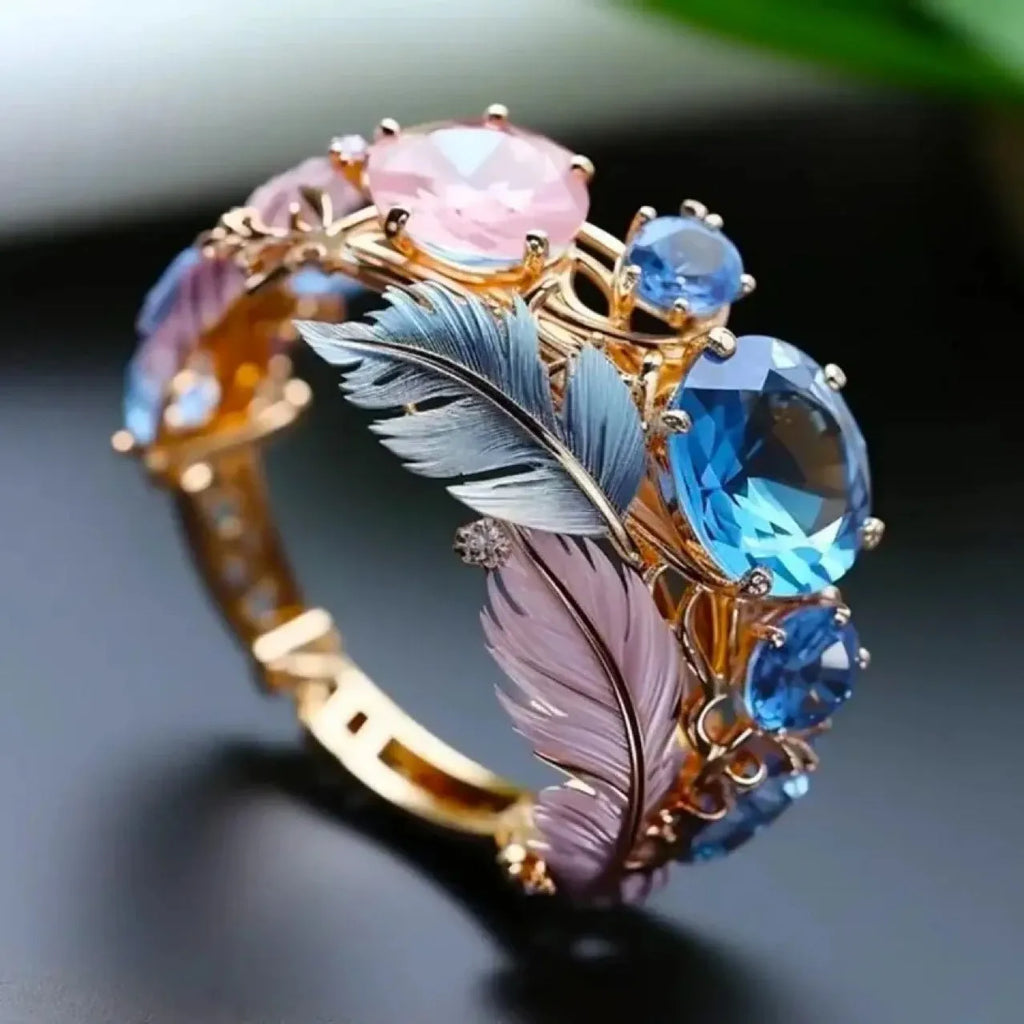 Gold brass ring with embossed feather design and zircon stone accents