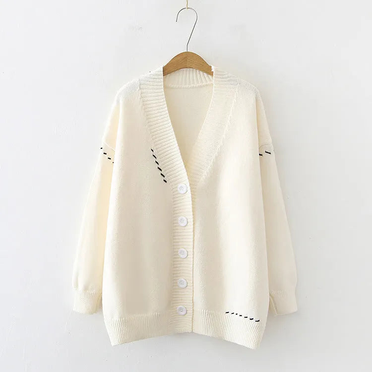 Women's loose knitted cardigan coat in solid white or black colour with long sleeves