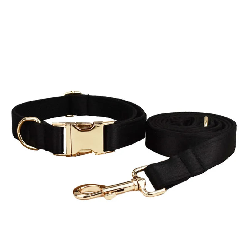 A soft cloth dog collar, leash, bow, and matching chest strap set laid out flat, showing coordinated colours.