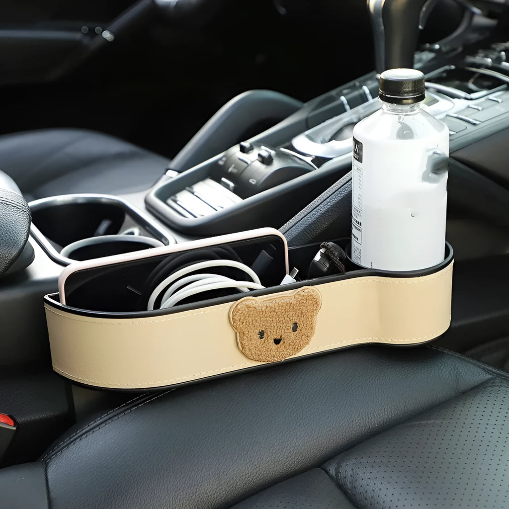 PU leather car seat gap storage box hanging between vehicle seats for small item organisation.