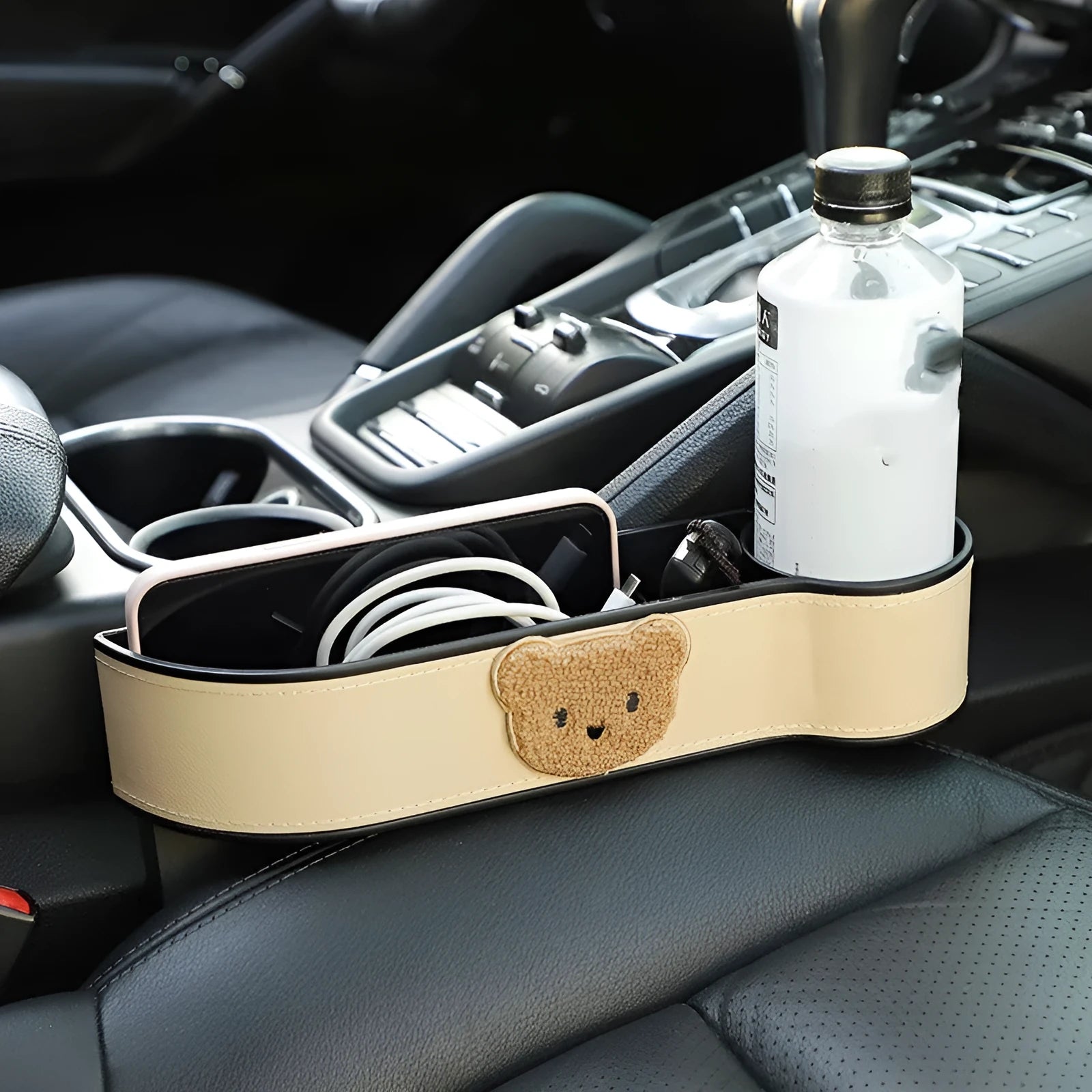 PU leather car seat gap storage box hanging between vehicle seats for small item organisation.