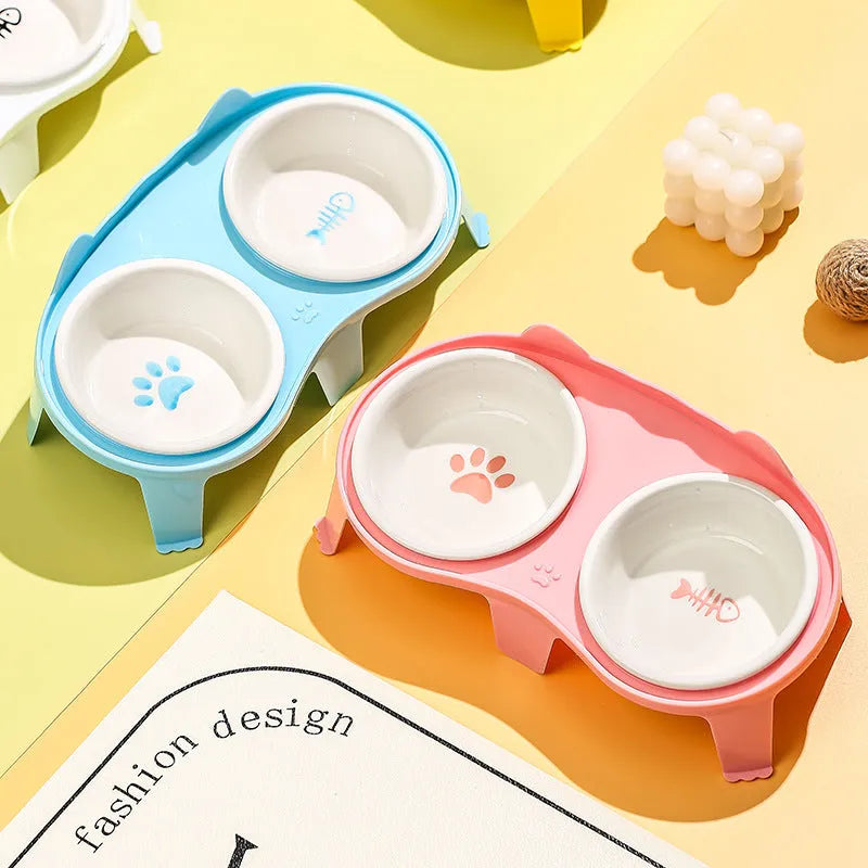 Blue ceramic cat food and water bowls in an elevated white ABS plastic stand with a hook