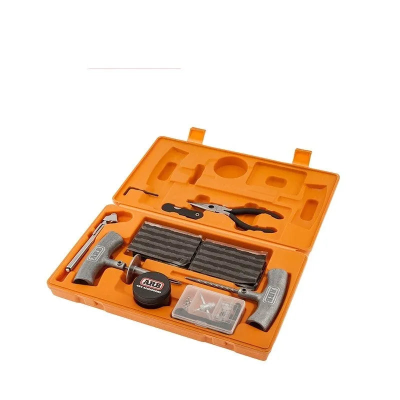 Speedy Seal tyre repair kit in a high-visibility suitcase, showing hex wrench, knife, pressure gauge, pliers, insertion tool, and reamer tool.