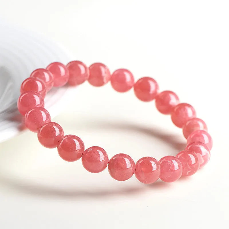 Women's geometric crystal bracelet with natural red patterned stone beads and longevity lock design element