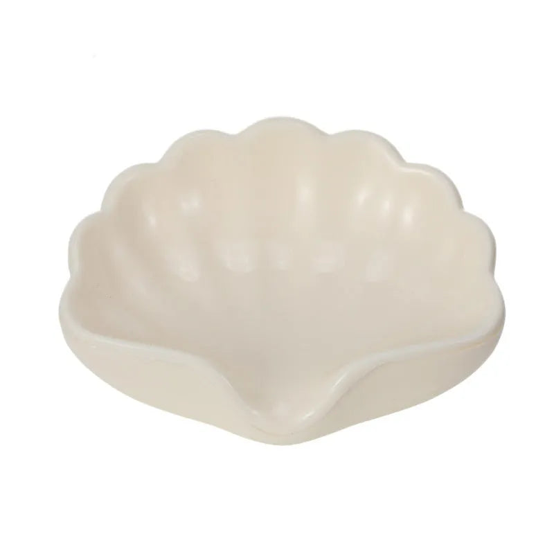 White or pink plastic shell-shaped soap dish for bathroom sink storage