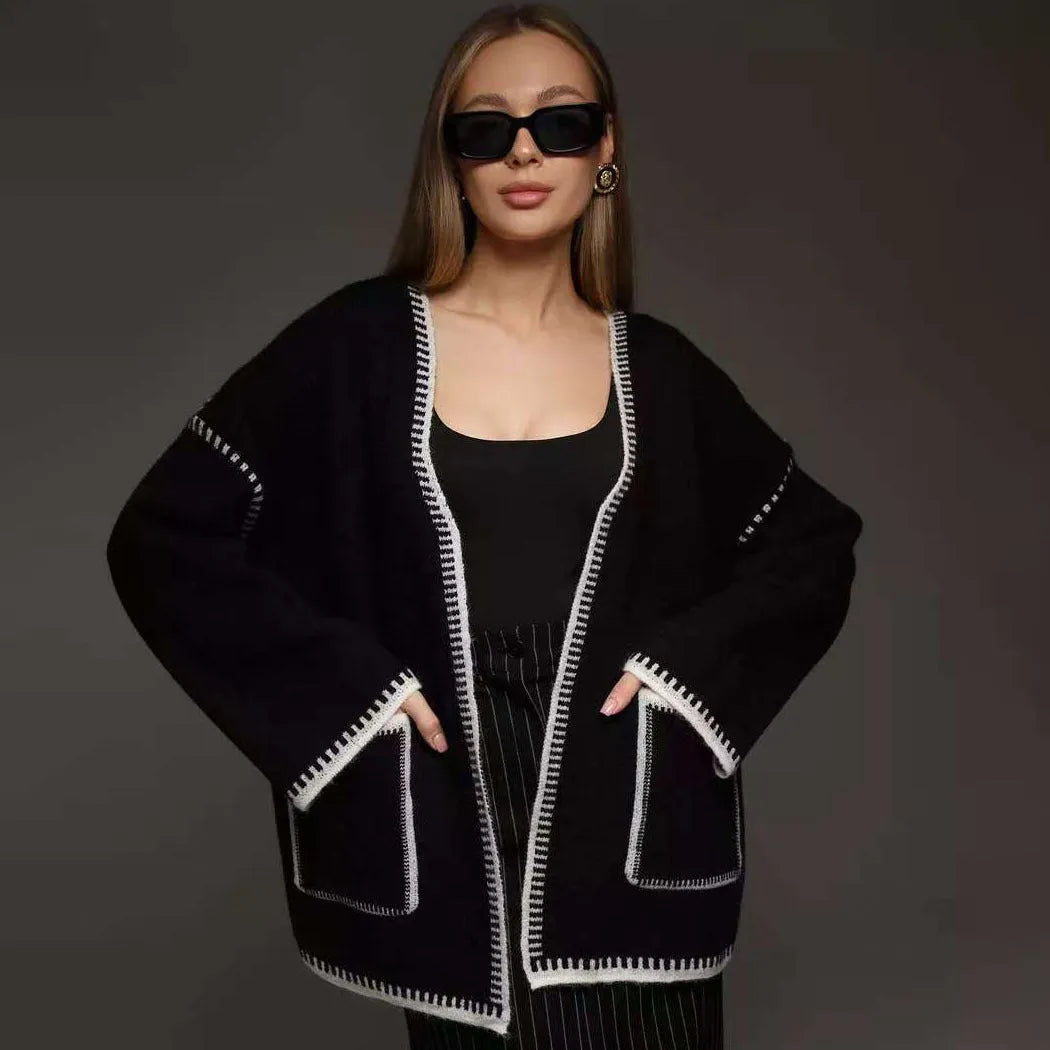 Loose fit knitted cardigan sweater coat in camel colour, showing long sleeves and mid-length hem.