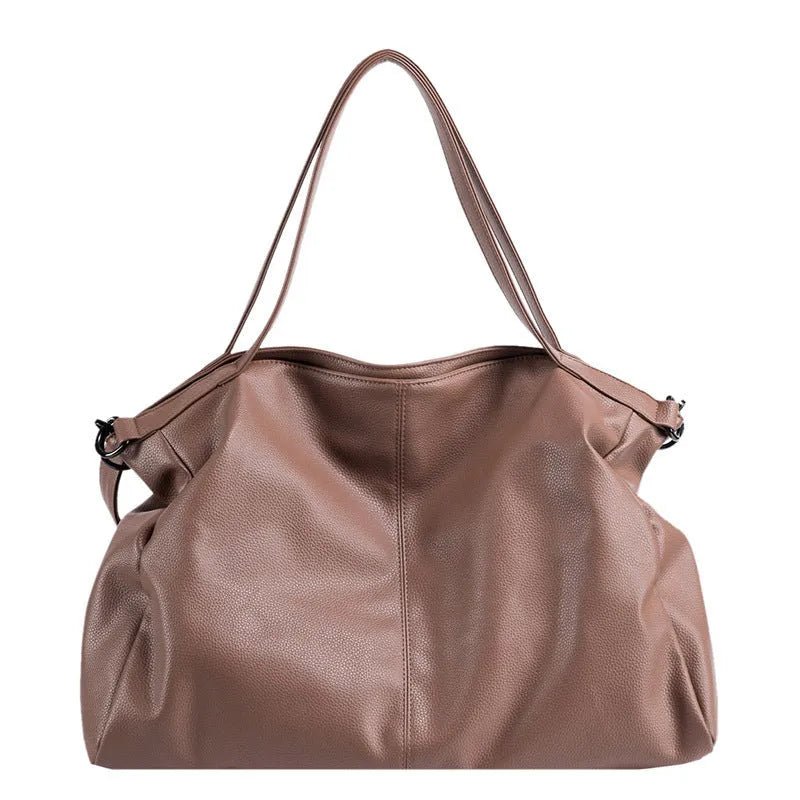 Large soft PU leather messenger bag with adjustable strap in black, shown open with internal pockets.