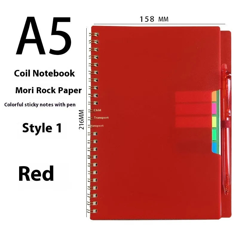 A5 erasable coil notebook with stone paper and pen on wooden surface