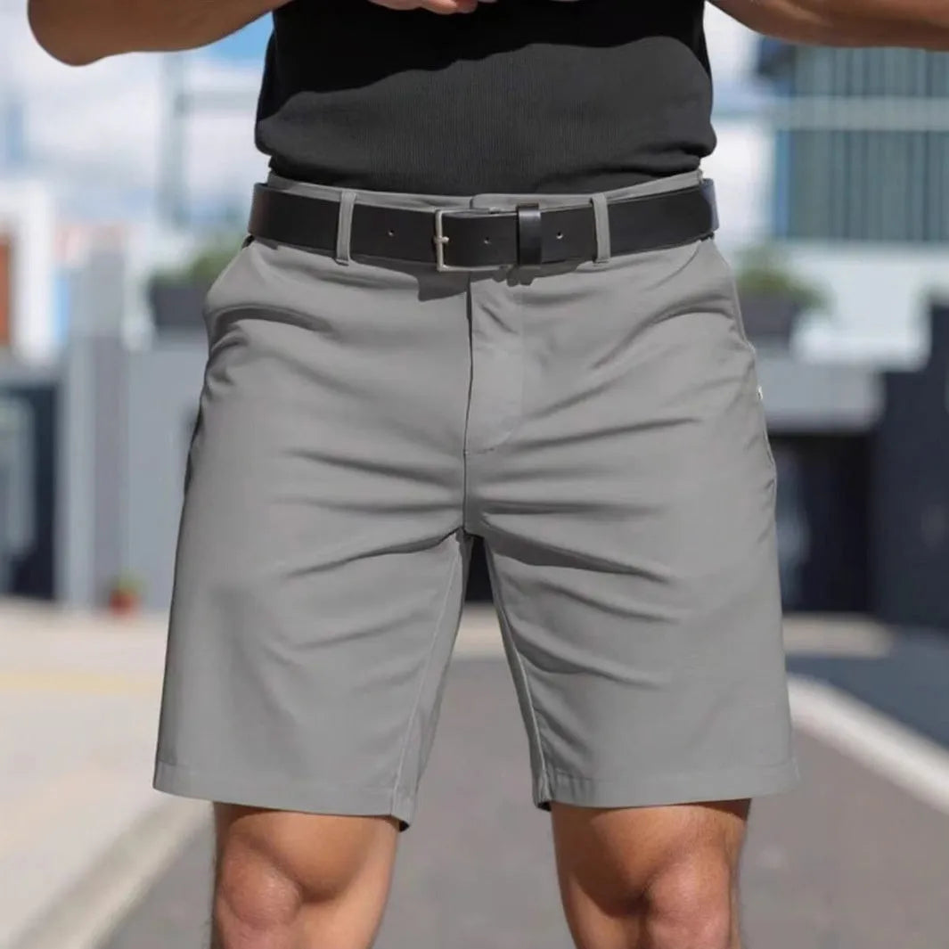 Man wearing straight-leg micro-elastic polyester fifth pants shorts in a choice of nine colours.
