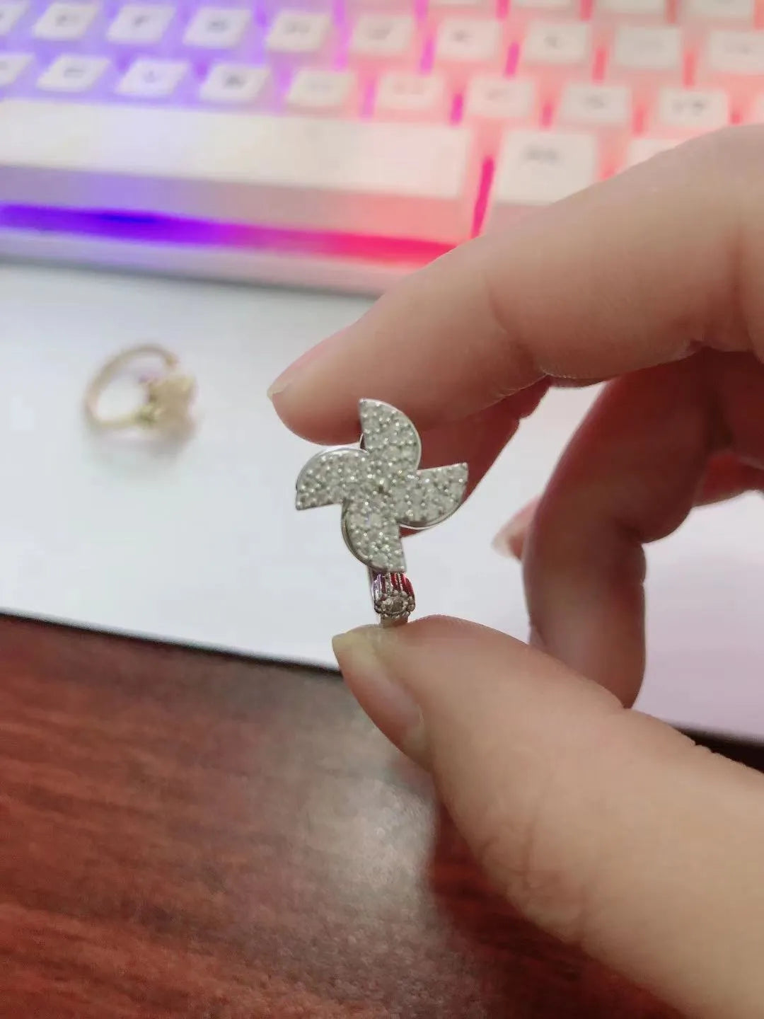 Rotating geometric ring with micro-inlaid windmill design in gold or silver electroplated finish