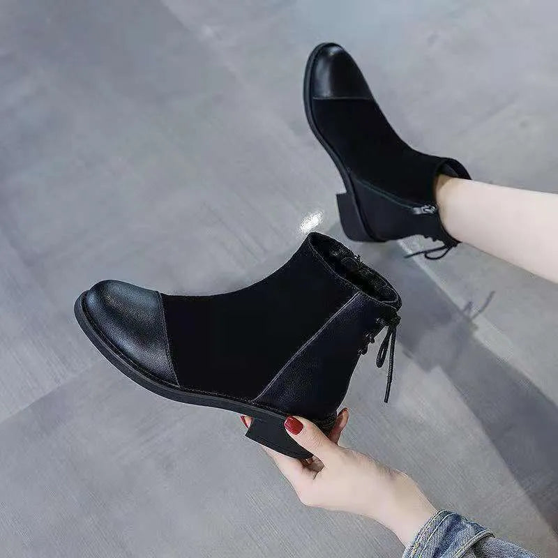 Black women's knee-high Martin boots with side zip and round toe on a short stout heel.