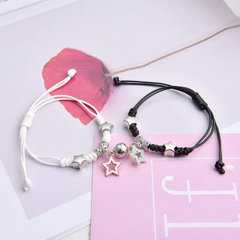 Pair of alloy suction bracelets with engraved symbol choices including crown, love lock, and clover.
