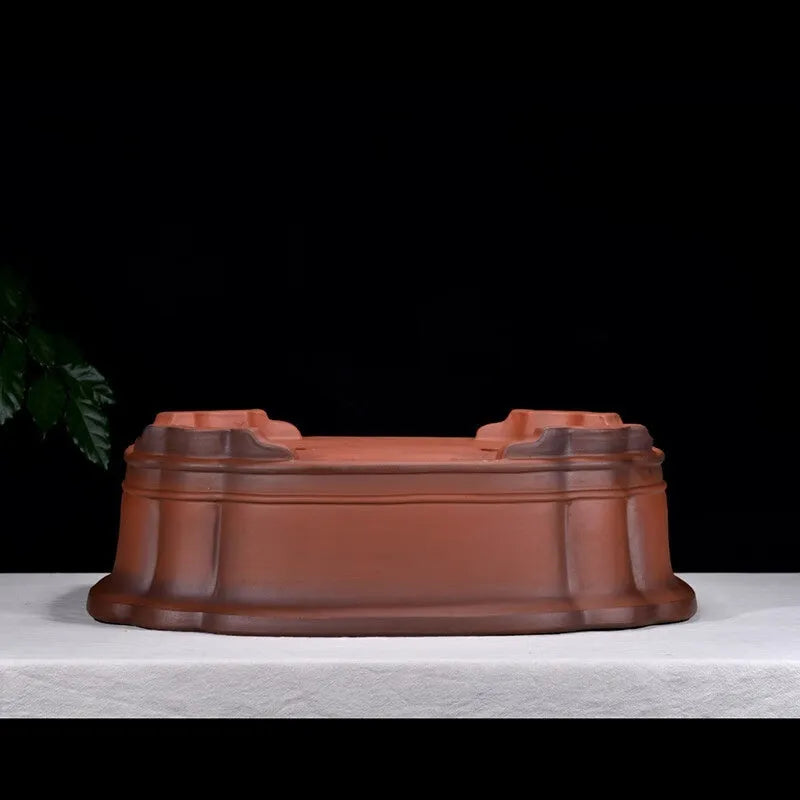 Large antique-finish Chinese purple clay flowerpot shaped like a tree stump with decorative carvings.