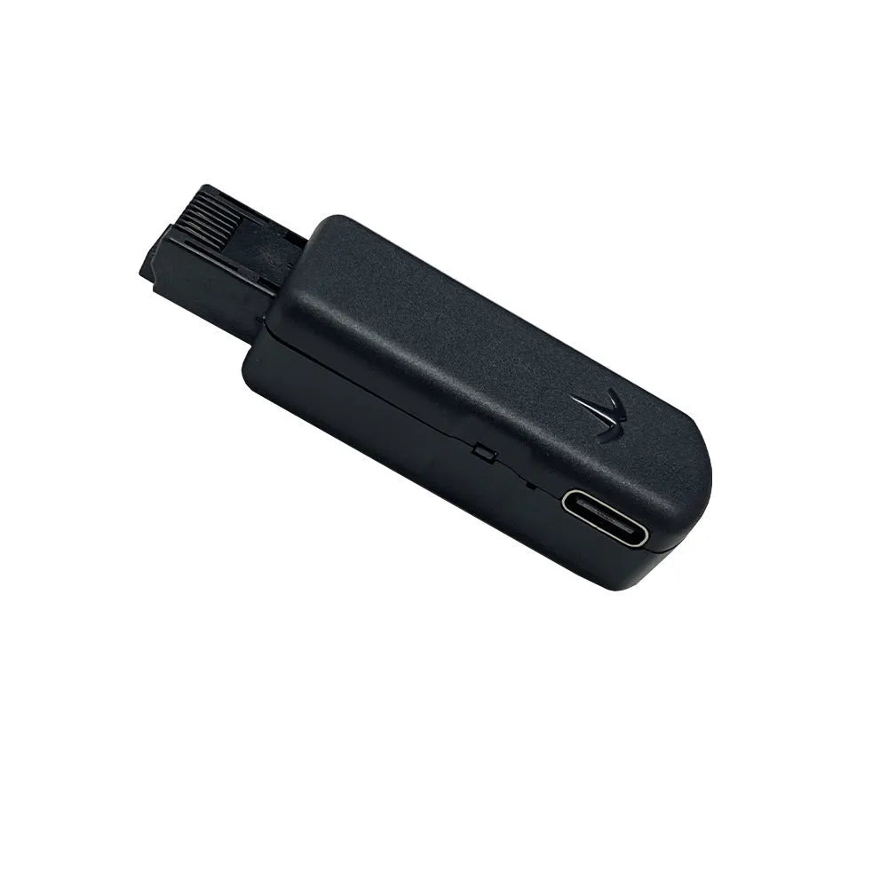 Black PS5 JB Tool USB adapter made of alloy and ABS plastic on a white background.