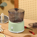 Mini electric meat grinder with transparent 225ml cup and stainless steel blades in light green or white