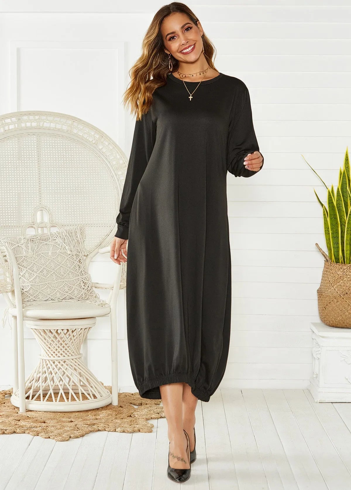 Loose black lantern dress with a lace-up crew neck, showcasing a relaxed silhouette.