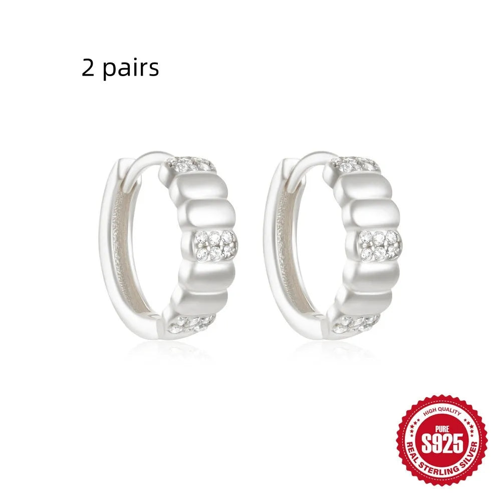 Sterling silver geometric stud earrings with small round designs in gold or silver electroplated finishes