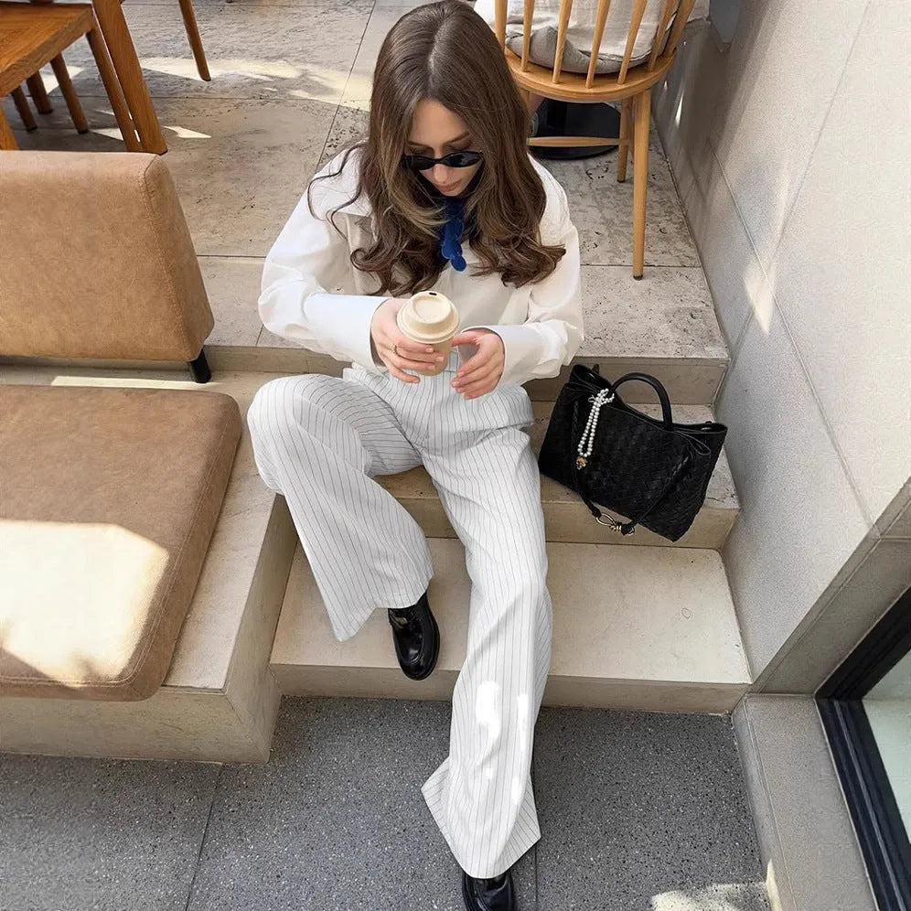 White striped wide-leg casual trousers with a front zip closure, shown in a loose fit.