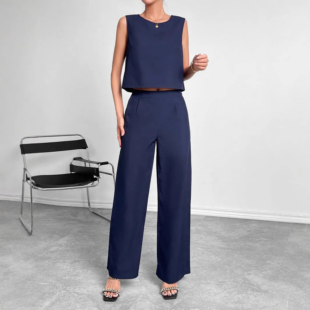 Red two-piece set with sleeveless round neck top and wide-leg trousers laid flat