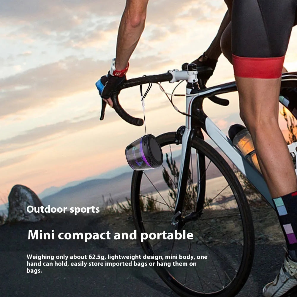 Compact portable Bluetooth speaker with ambient light ring and magnetic base in black or white