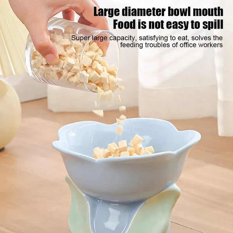 Blue floral patterned raised ceramic pet bowl for cats and dogs on a non-slip base.