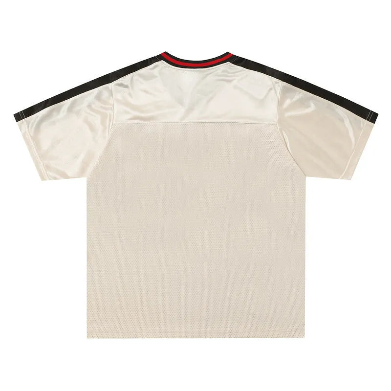 Apricot coloured men's V-neck short sleeve sports jersey with a loose fit and letter pattern detail.