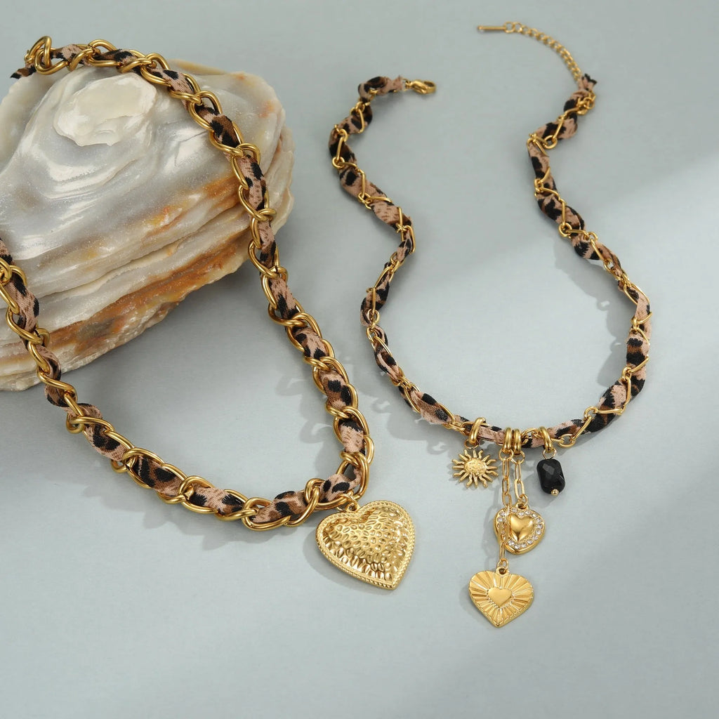 Gold-plated stainless steel necklace with leopard and love geometric pendant on an adjustable chain.