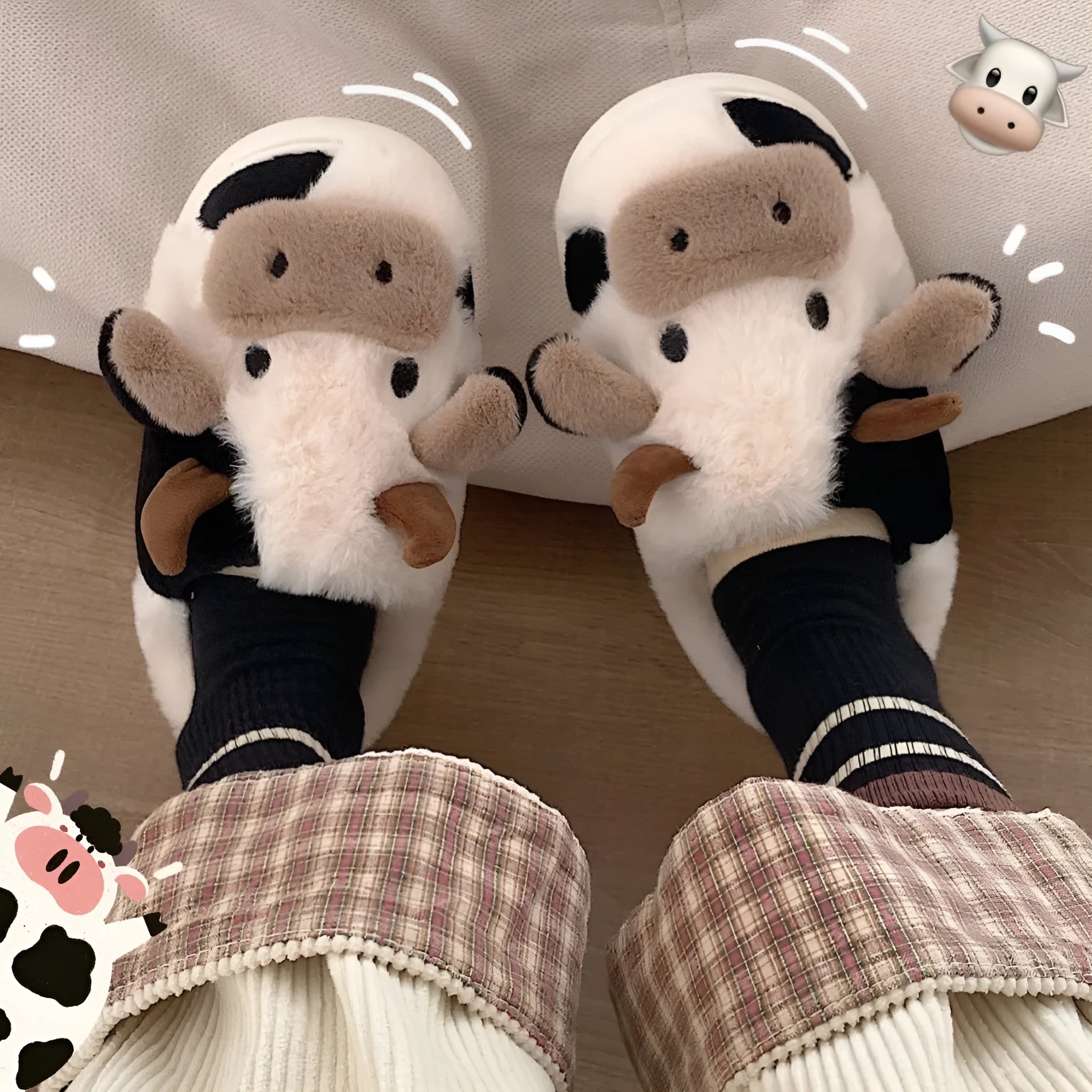 White cow-themed faux fur slippers with plush lining and textured non-slip soles.