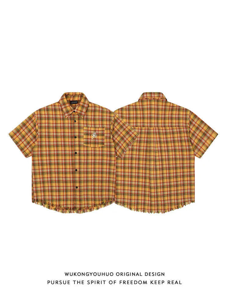 Yellow plaid loose fit short sleeve shirt with embroidered detail on the chest pocket.