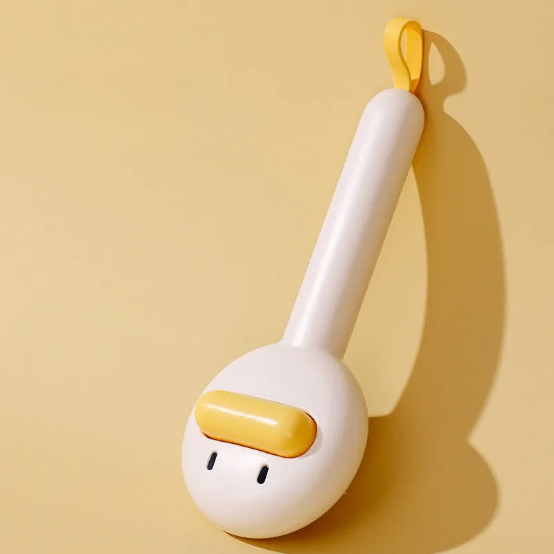 Small yellow duck-shaped pet grooming comb with open section design and needle pins for hair removal