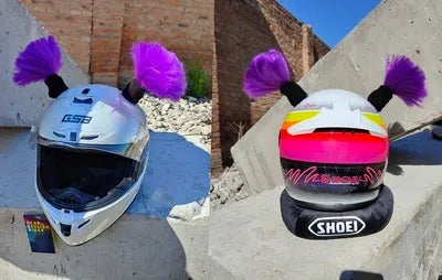 Pair of decorative braided balls for helmet customisation next to a tube of adhesive