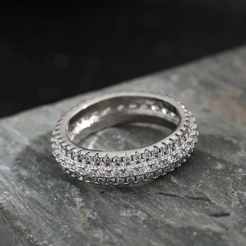 Geometric copper ring with triangular zircon inlay, shown in white gold plating.