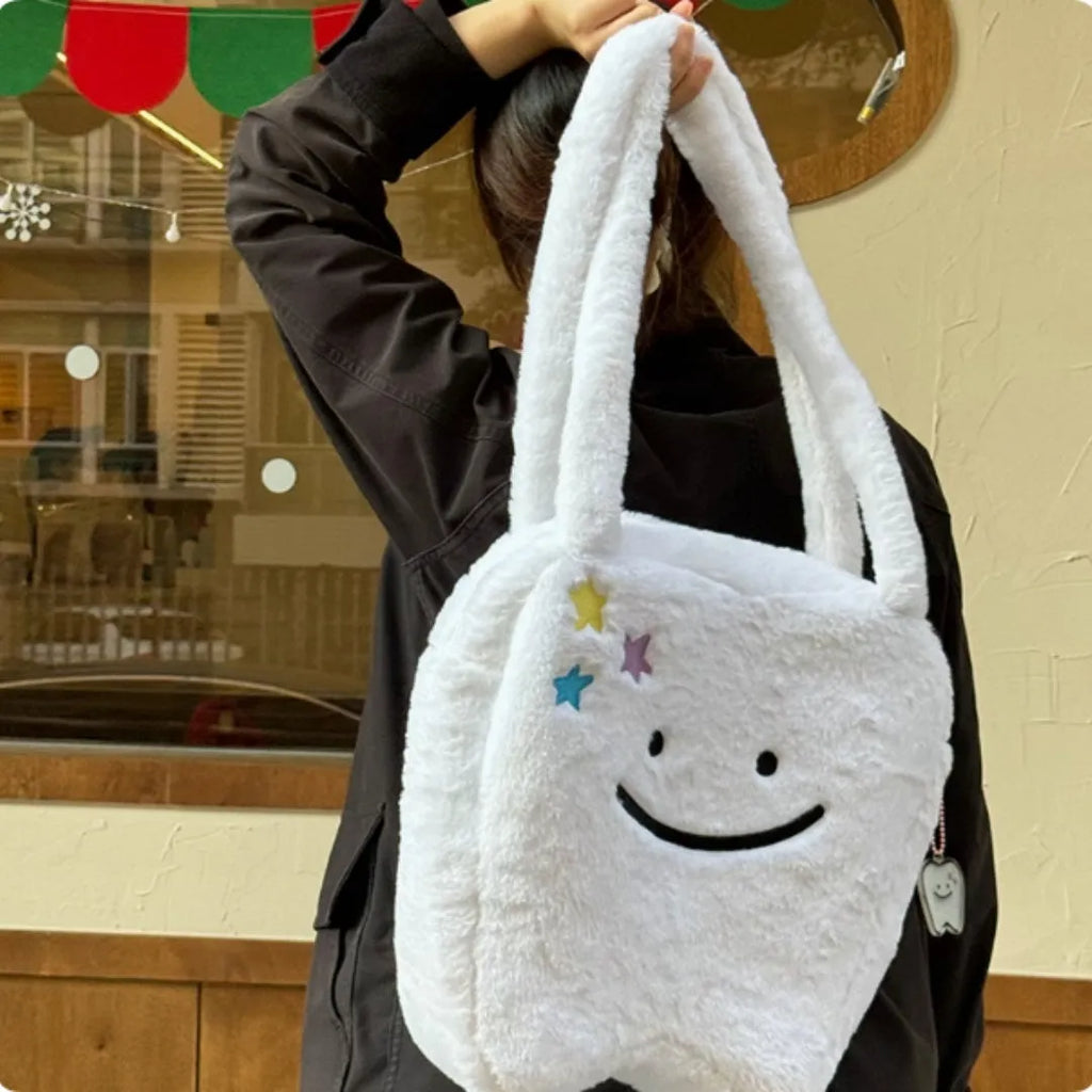 White plush large tooth shoulder tote bag with crossbody strap and zipper.