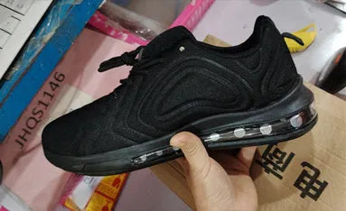 Men's black casual sneakers with lace-up front, thick sole, and round toe design