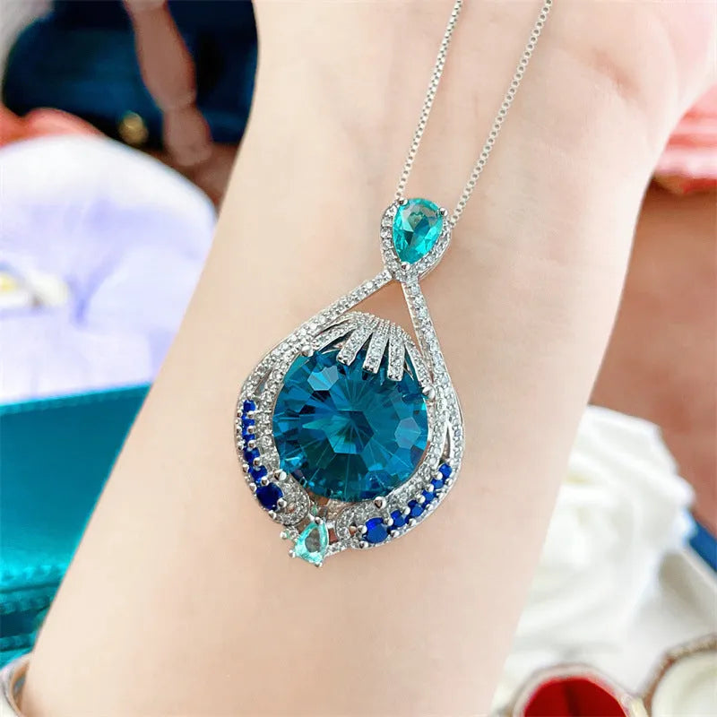 Blue geometric crystal pendant necklace with fireworks cut design on water wave chain