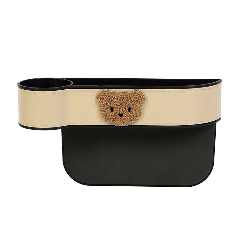 PU leather car seat gap storage box hanging between vehicle seats for small item organisation.