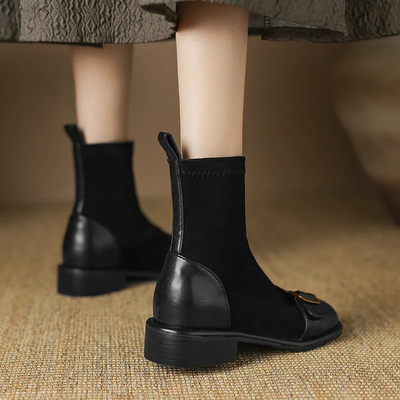 Black women's low heel Martin ankle boots with front lace-up and metal buckle detail on a white background.