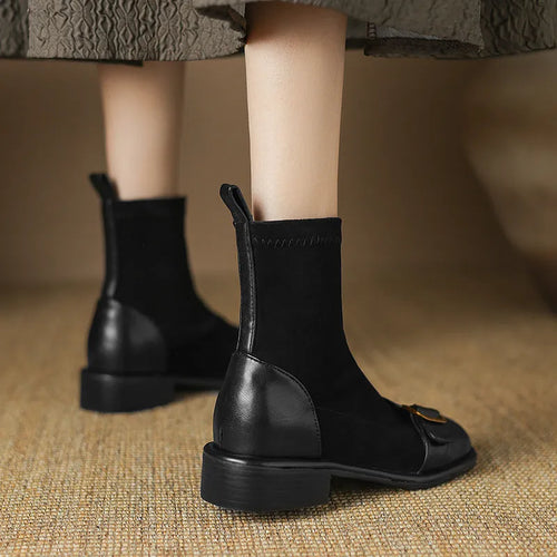 Black women's low heel Martin ankle boots with front lace-up and metal buckle detail on a white background.