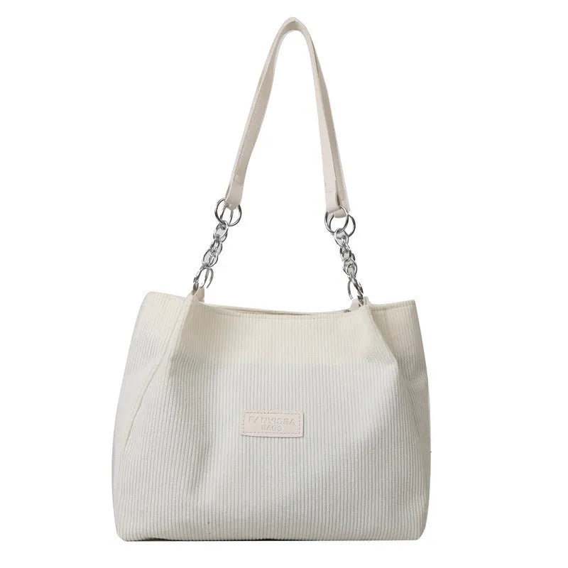 Corduroy one-shoulder tote handbag in a horizontal square shape, shown in brown colour.