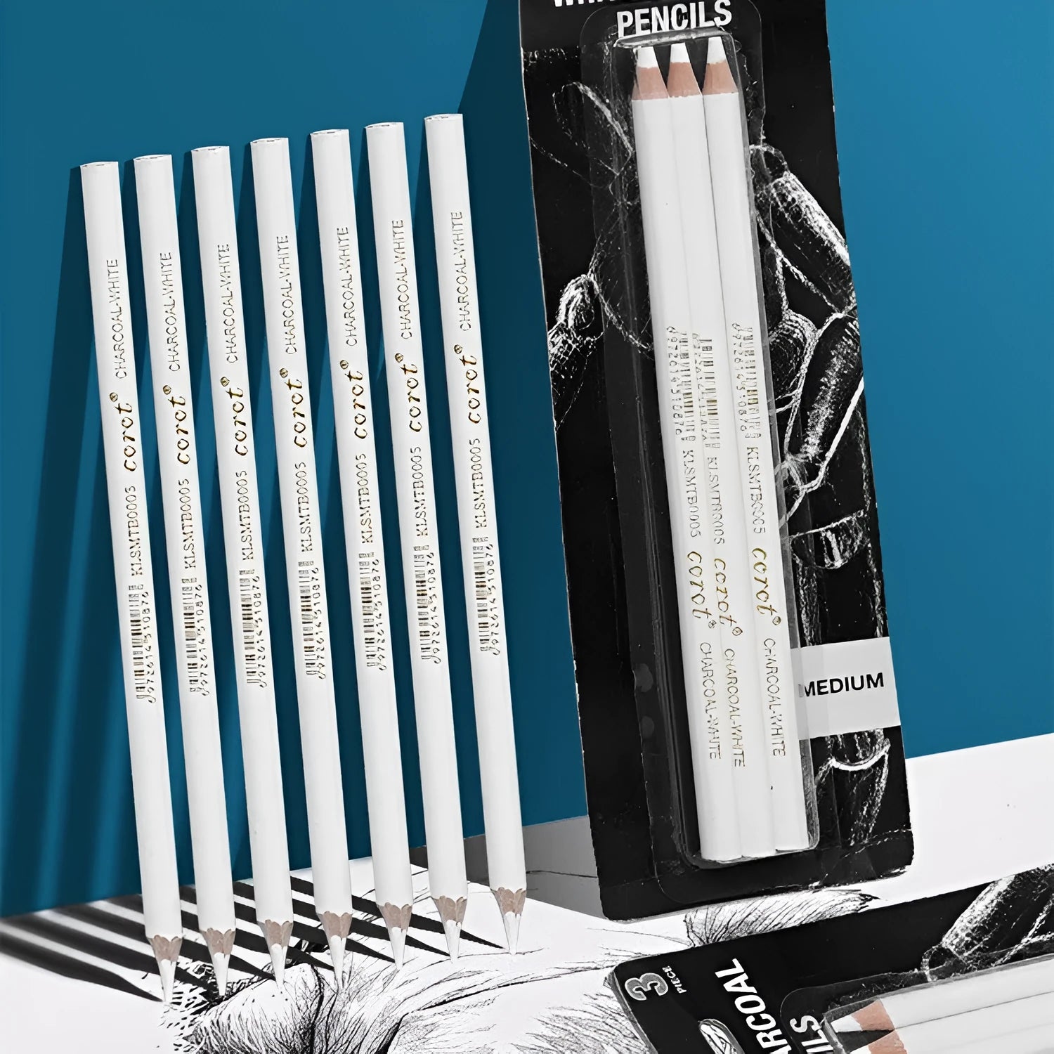 Three white charcoal sketching pencils with wooden barrels for highlighting on dark paper