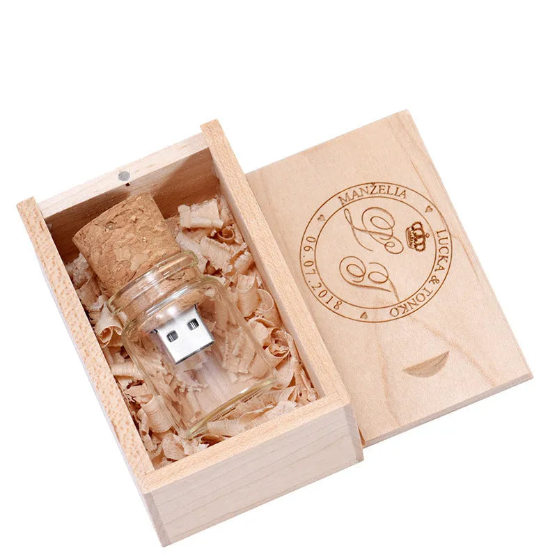 Personalised wooden drift bottle-shaped USB flash drive showing custom graphic on its side.