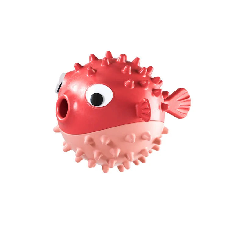 Green fish-shaped dog chew toy with treat dispensing hole and textured surface